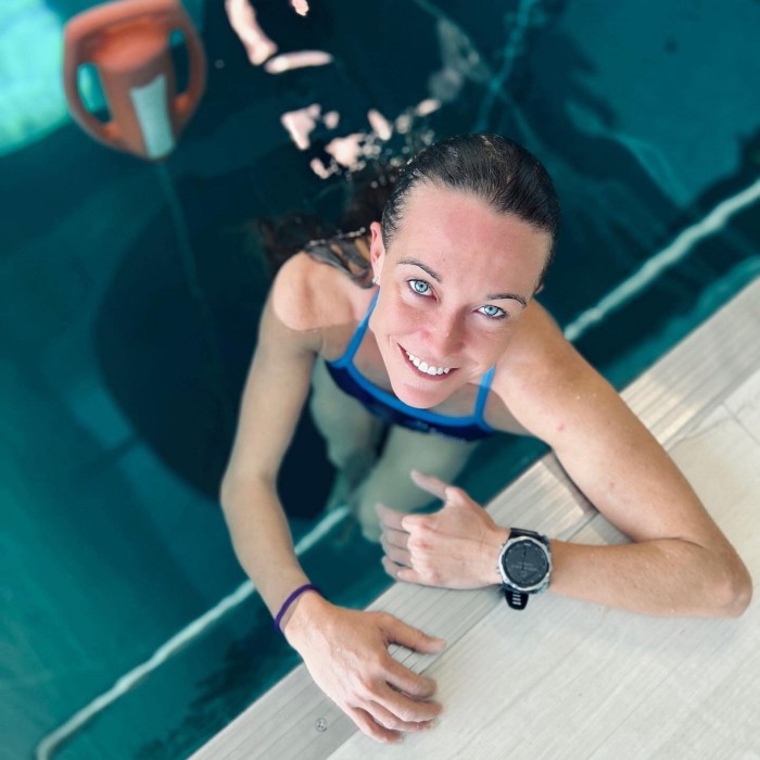 A female freediving world champion swimming in the pool