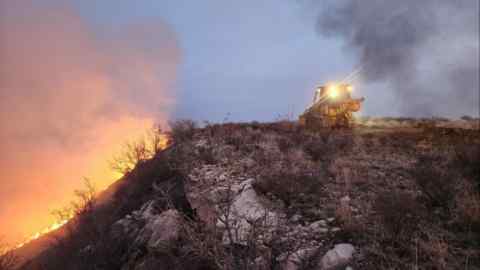 Texas A&M Forest Service bulldozer building a containment line as it battles the Windy Deuce Fire in Moore County, Texas