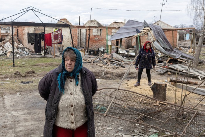 Hanna Khlystun stands amongst destroyed houses in the village of Yahidne, near  Chernihiv, Ukraine