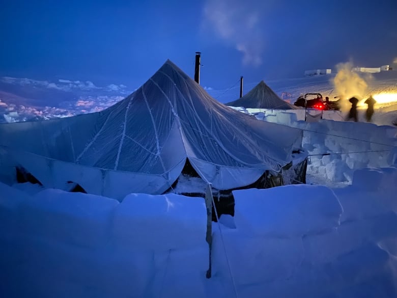 A tent surrounded by snow bricks.