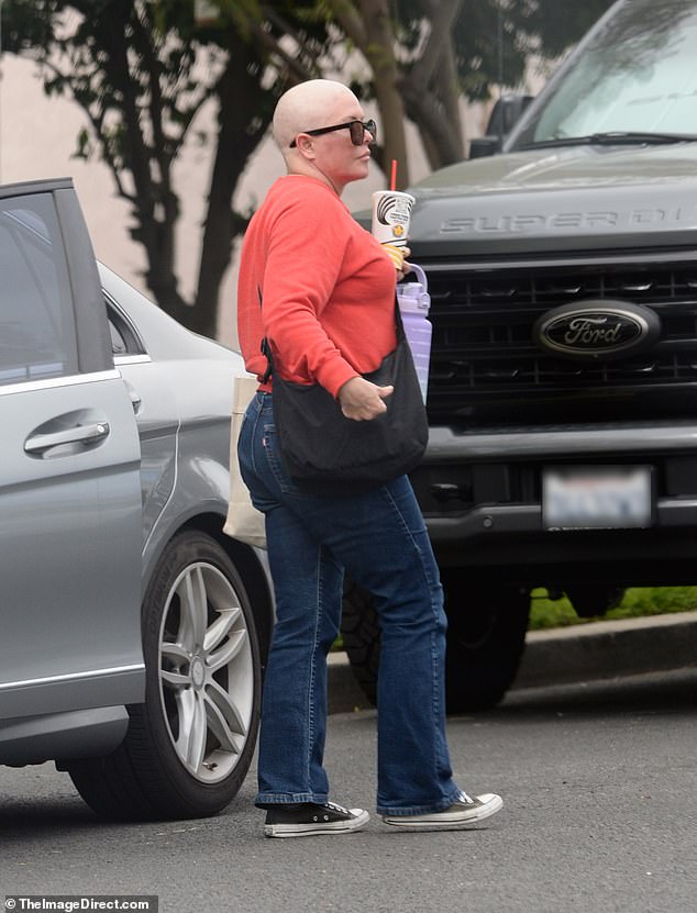 For her laid-back outing, the Glendale native sported a pair of oversized black sunglasses, a red crewneck sweatshirt and dark-wash jeans