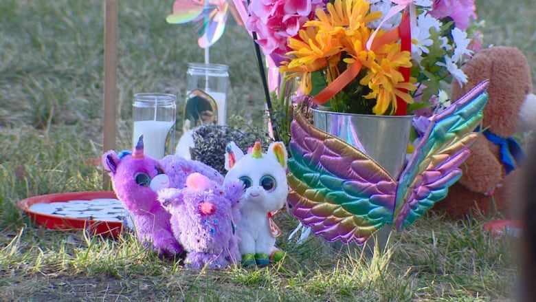 Stuffed animals, flowers and candles 