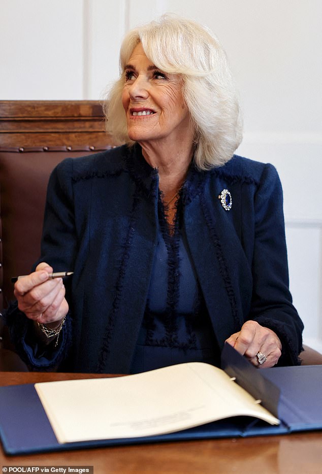 Her Majesty appeared cheerful as she signed a book at Douglas Borough Council