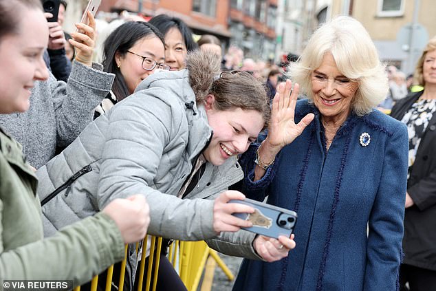 Her Majesty appeared in high spirits as she waved for a selfie with a member of the public