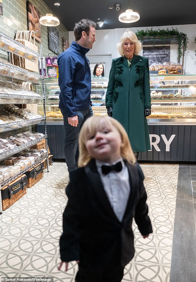 The youngster posed for the cameras as Camilla visited Knotts bakery in Belfast today