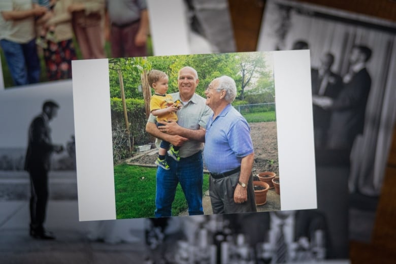 A photo collage with an image of a little boy held by his grandfather next to his great grandfather in a garden.