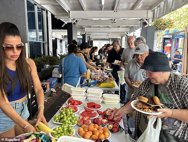 Mr Mezei, along with his staff and family, volunteer in helping the Chopping Circle - a charity which provides food for homeless and food-stressed households - in Martin Place every second Sunday (pictured)