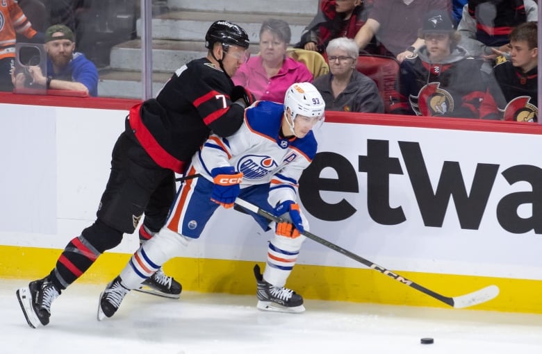 Brady Tkachuk of the Ottawa Senators is seen battling with Ryan Nugent-Hopkins of the Edmonton Oilers during a March 24 game at the Canadian Tire Centre in Ottawa.