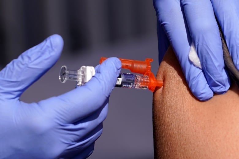 A person receives a needle