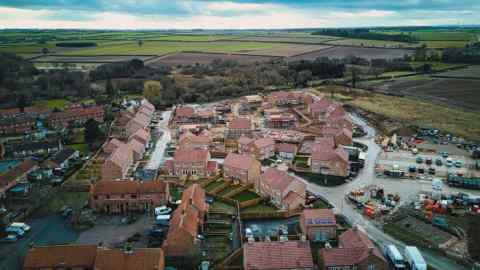 House building on edge of countryside