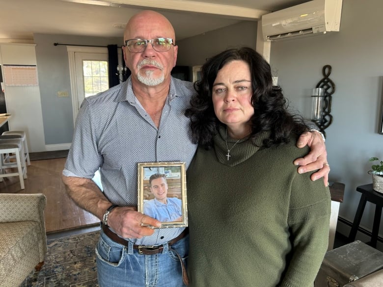 Carl Burke and Barbie Lavers hold up a photo of Harry Burke.