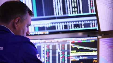 Traders work on the floor of the New York Stock Exchange