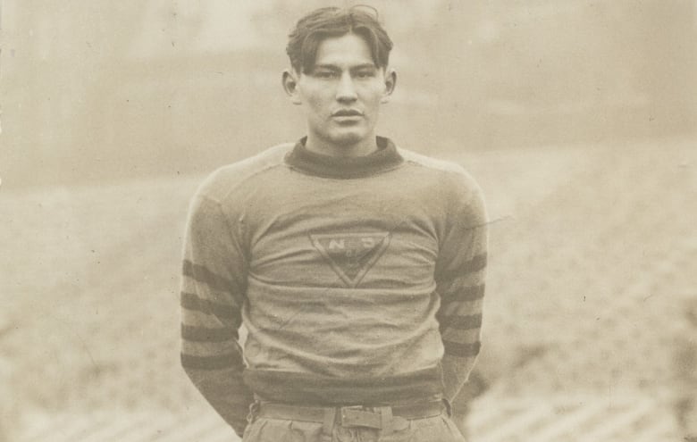 A black and white pictured of man wearing rugby gear is shown.