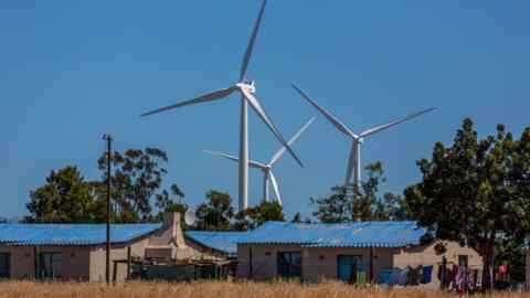 Wind turbines beyond residential buildings at a wind farm