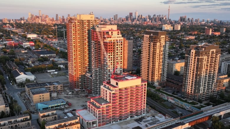 Aerial (drone) images of condo and apartment construction in Toronto's west end during sunrise.