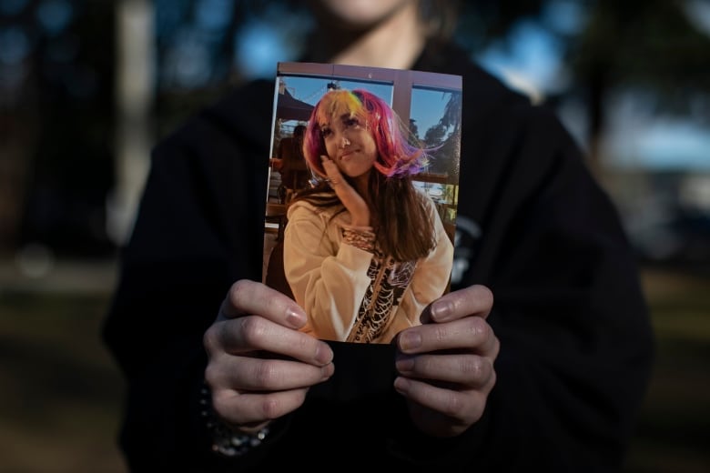 A close friend holds a picture of her 14-year-old friend Kamilah Sword who died of an apparent drug overdose in Port Coquitlam, Monday February 26, 2023.