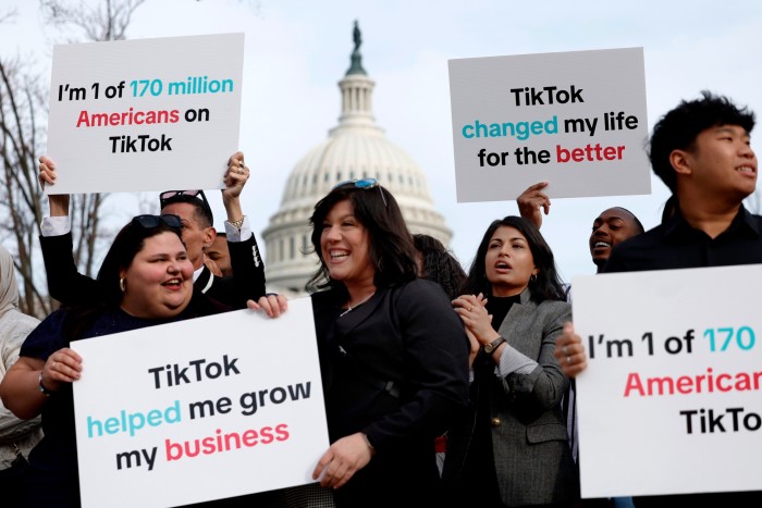 Participants hold signs in support of TikTok outside the US Capitol building