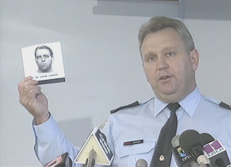 A Halton Regional Police officer is seen in 1995 holding a composite sketch of the child sex predator dubbed the "woodland rapist."