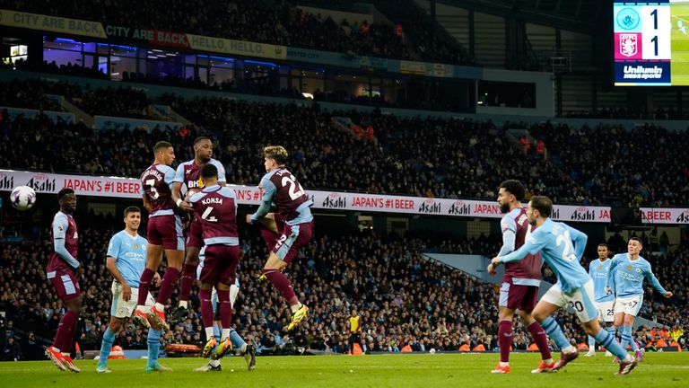 Phil Foden watches his free kick beat Robin Olsen in the Villa goal