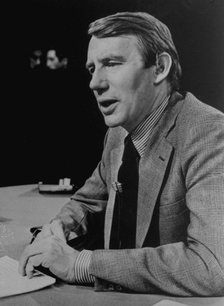 A black and white photo of a young news anchor.