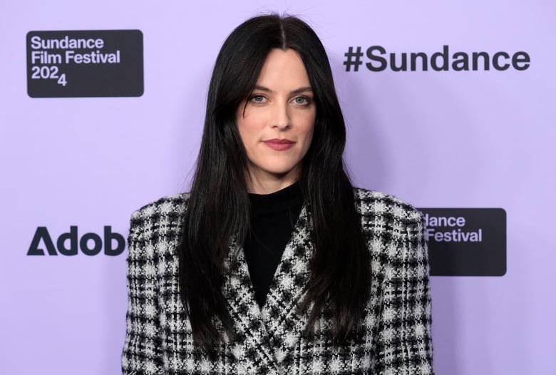 An actress poses for press photograph during a film festival. 