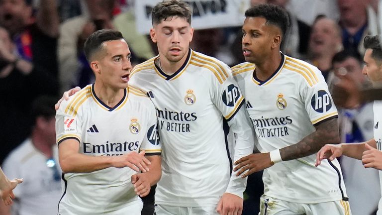 Real Madrid's Lucas Vazquez, second left, celebrates with his teammates after scoring his side's second goal during the Spanish La Liga soccer match between Real Madrid and Barcelona at the Santiago Bernabeu stadium in Madrid, Spain, Sunday, April 21, 2024. (AP Photo/Manu Fernandez)