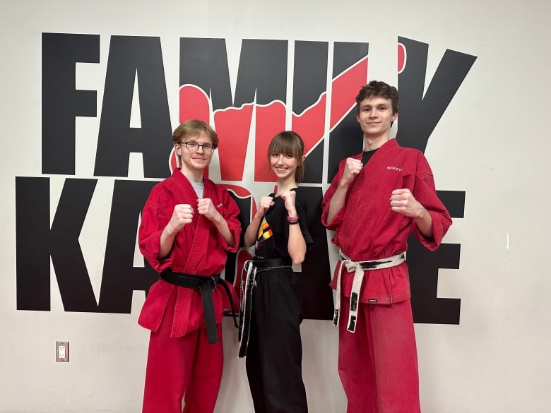 Eccaia Sampson with her instructors Jake Lindsay, left, and Nathan Parker, right. The two have worked with Sampson at Family Karate at London's Sherwood Forest Mall since she was a child. 