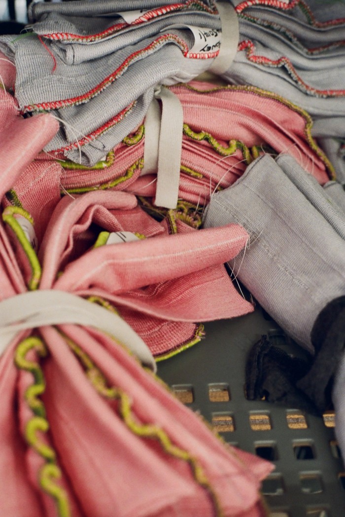 Bundles of pink and grey material with a ribbon around the middle