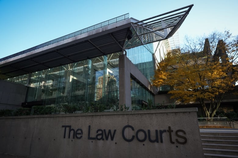 A glass and concrete building featuring the sign "The Law Courts".