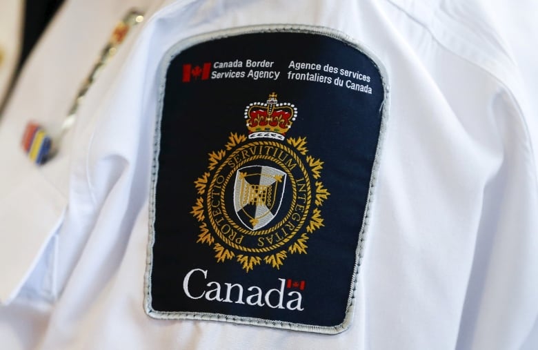 A CBSA badge on a uniform officer.