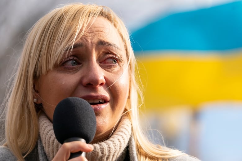 Ukrainian Parliament member Oleksandra Ustinova cries as she speaks during a protest against Russia's war on Ukraine in Lafayette Park near the White House on Sunday, March 13, 2022 in Washington.