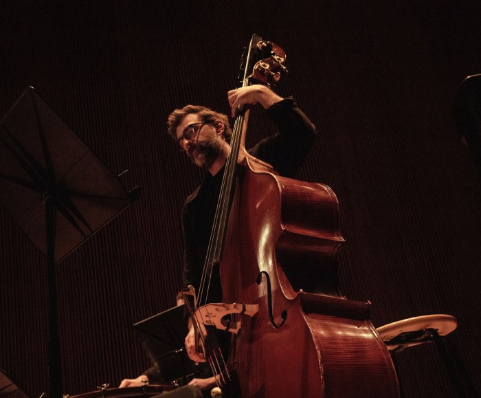 A man plays a double bass with a bow