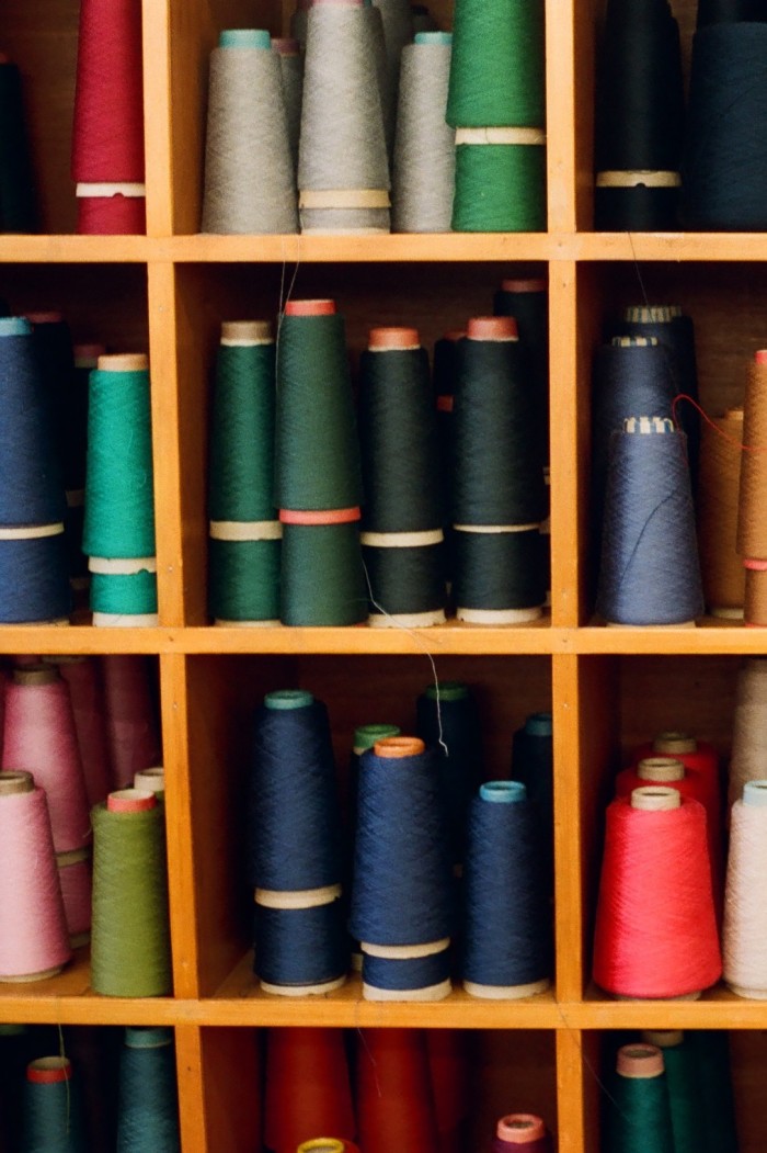 Shelves full of multi-coloured yarns