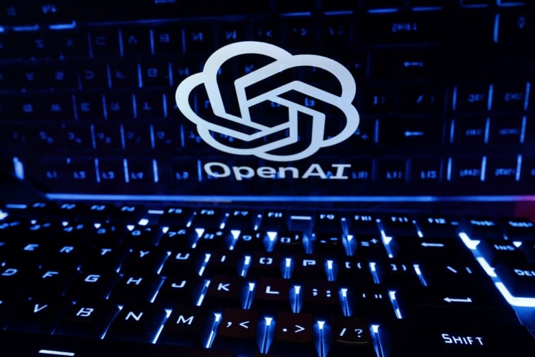 A keyboard is placed in front of a displayed OpenAI logo. 