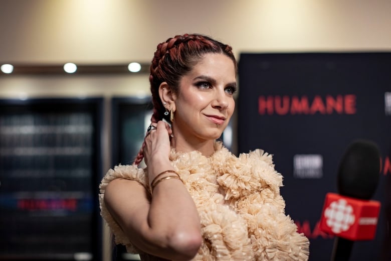 A woman poses on the red carpet. 