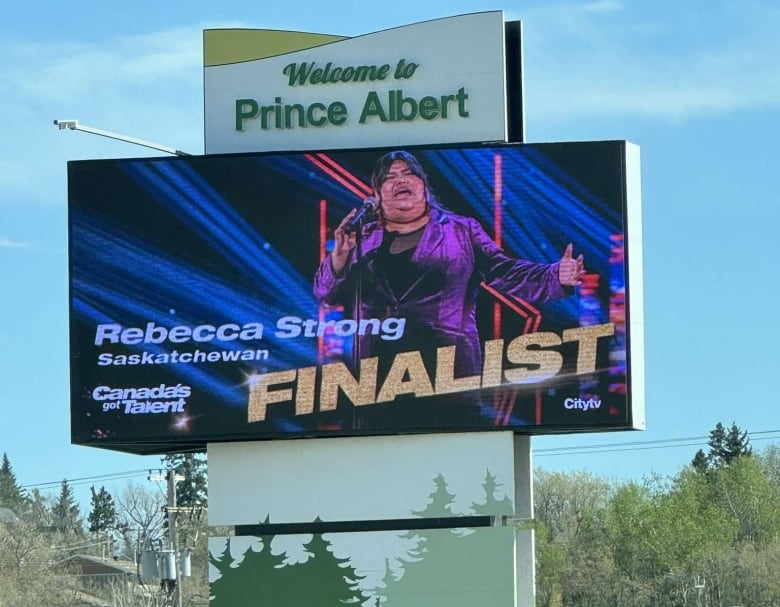 A sign stating their support for Rebecca Strong hang off the Prince Albert welcome sign.