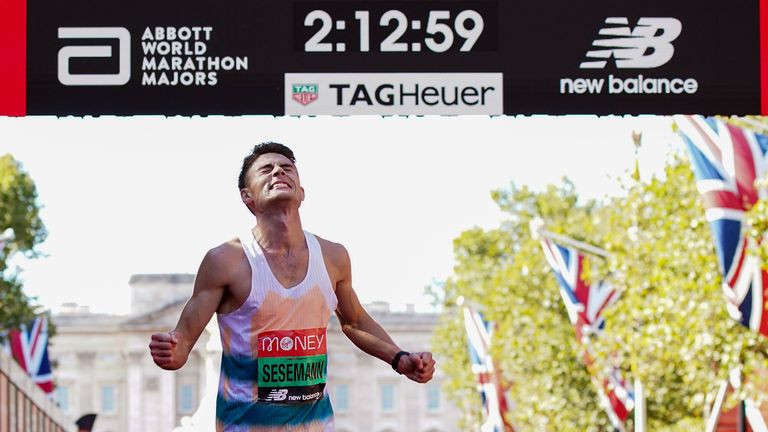 Phil Sesemann crosses the finish line during the Virgin Money London Marathon in 2021