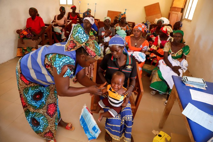 A nurse administers a malaria vaccine in Cameroon in January