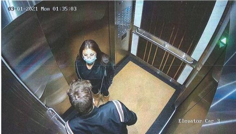 A man and woman in an elevator.