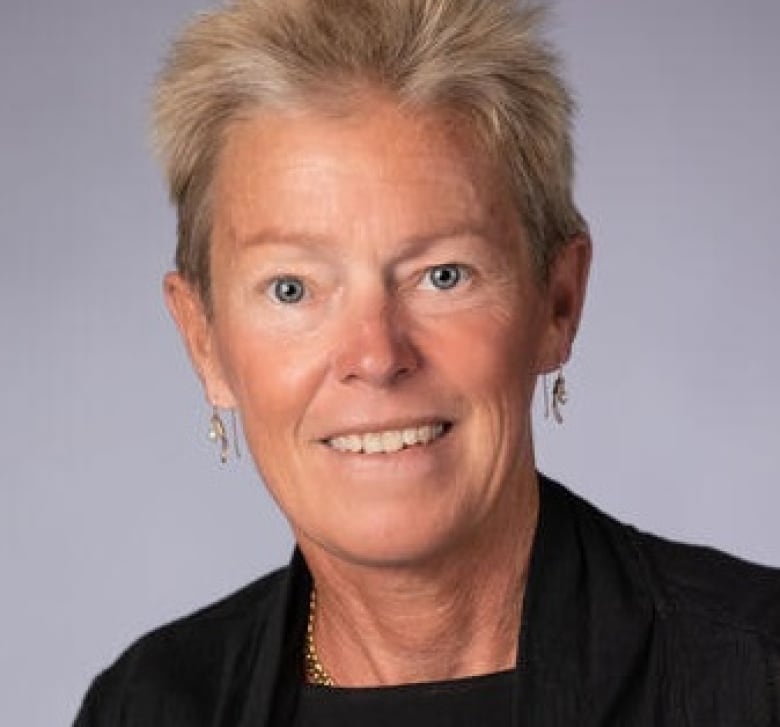 A woman looks to the camera during a photoshoot.