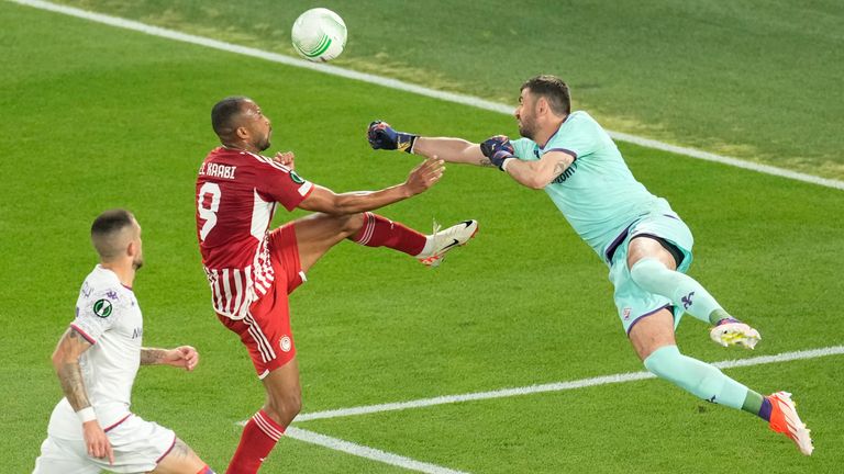 Fiorentina's goalkeeper Pietro Terracciano blocks Olympiakos' Ayoub El Kaabi's shot during the Conference League final