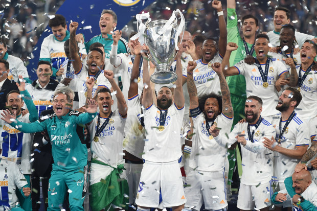 Karim Benzema of Real Madrid lifts UEFA Champions League Trophy following his team's victory.