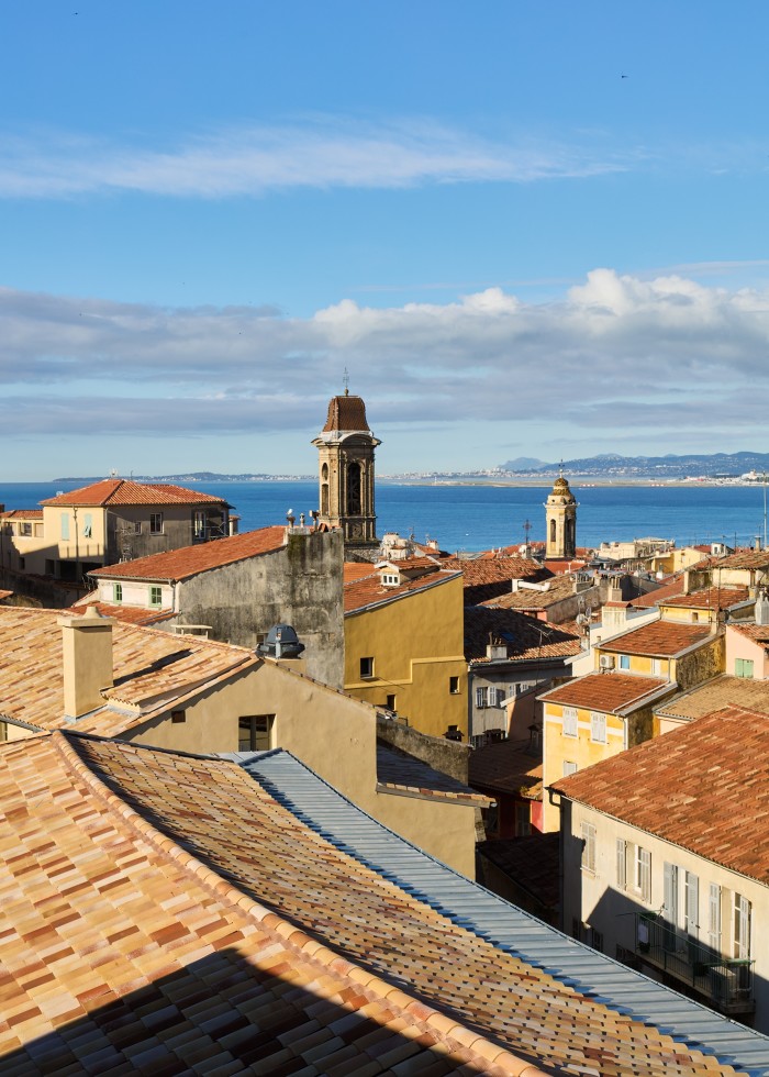 A view across the city rooftops to the sea from La Tour suite