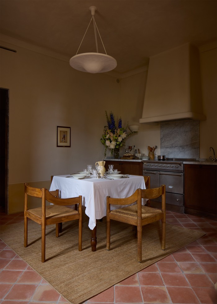 A table set in Terrasse du Cloître suite; on the wall hangs a 1920 Picasso gouache for the costume design of Le Tricorne, commissioned by Serge Diaghilev