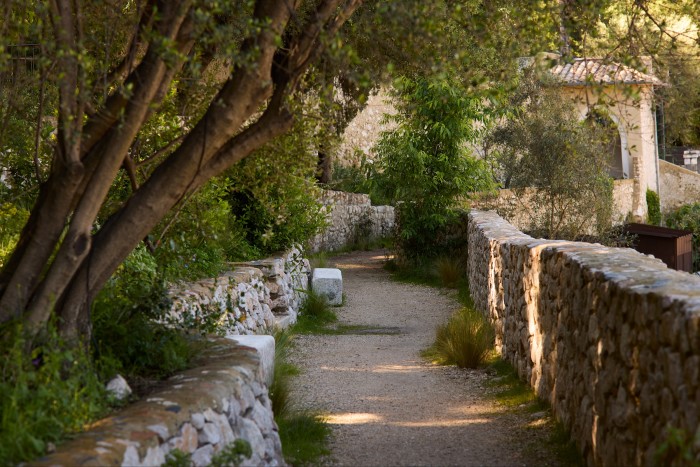 The long path in the garden, which has been designed and restored by a team led by Tom Stuart-Smith in its original style of terraces and courtyards