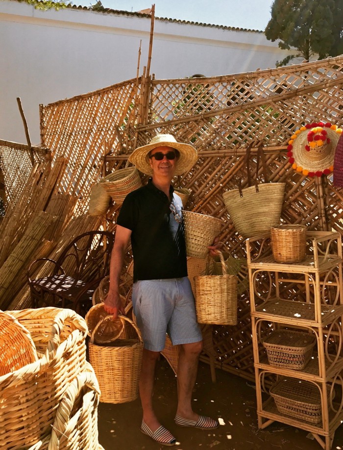 a man standing amid baskets 