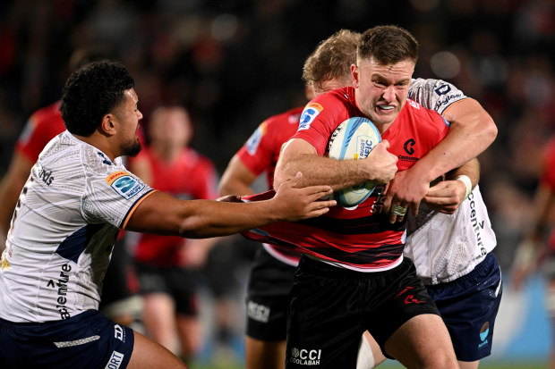 Fergus Burke of the Crusaders is tackled.