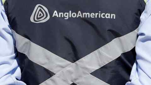 Logo of Anglo American is seen on a jacket of an employee of the Los Bronces copper mine