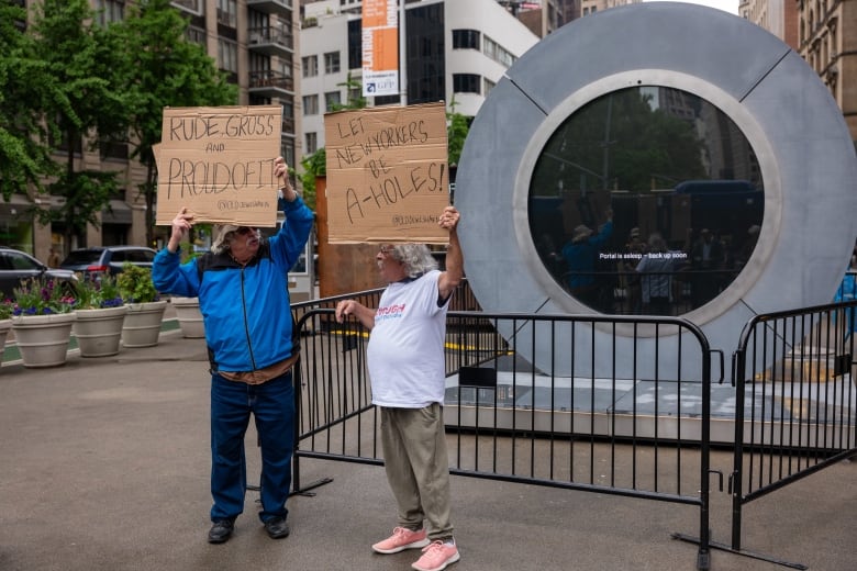 Two old men stand in the streets in front of a large circle with a screen that reads "Portal is asleep. Be back soon." The men are holding hand-drawn cardboard signs. One reads "RUDE AND GROSS AND PROUDOFIT" and the other says "Let New Yorkers Be A-HOLES!" Both signs are signed "@OLDJewishMen."