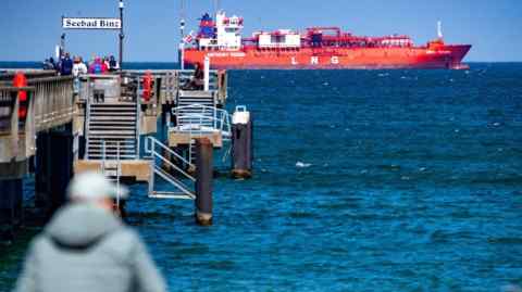 A tanker ship sits off the coast